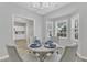 Lovely dining area with seating for four, modern lighting, and stylish decor that is set for a delightful meal at 220 Misty Groves Cir, Morrisville, NC 27560