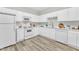 Contemporary kitchen with white appliances, ample cabinet space, and stylish flooring offers a clean and efficient design at 220 Misty Groves Cir, Morrisville, NC 27560