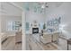 Light and bright living room featuring a fireplace, ceiling fan, and neutral tones, with a peek into the primary bedroom at 220 Misty Groves Cir, Morrisville, NC 27560