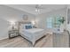 Main bedroom featuring a ceiling fan, a side table, a dresser, and natural light at 220 Misty Groves Cir, Morrisville, NC 27560