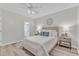 Main bedroom featuring a ceiling fan, side tables, and natural light at 220 Misty Groves Cir, Morrisville, NC 27560