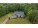 Stunning aerial view of a well-maintained home with lush landscaping and a sprawling lawn surrounded by mature trees at 2208 Wimberly Woods Dr, Sanford, NC 27330