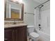 A bathroom features a vanity with granite countertop and a shower-tub combination at 2208 Wimberly Woods Dr, Sanford, NC 27330