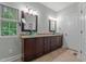 Stylish bathroom featuring dual vanity sinks, granite countertops, and modern fixtures at 2208 Wimberly Woods Dr, Sanford, NC 27330