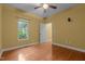 A bright bedroom features wood floors, a ceiling fan, and a large window at 2208 Wimberly Woods Dr, Sanford, NC 27330