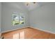 A bright bedroom with hardwood floors and a large window with street view at 2208 Wimberly Woods Dr, Sanford, NC 27330