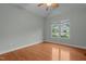 Bright bedroom with hardwood floors and large windows that provide a neighborhood view at 2208 Wimberly Woods Dr, Sanford, NC 27330