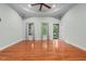 Spacious bedroom featuring hardwood floors, modern lighting, and an exterior door at 2208 Wimberly Woods Dr, Sanford, NC 27330