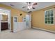 A bright bedroom featuring carpet, a ceiling fan, and bathroom access at 2208 Wimberly Woods Dr, Sanford, NC 27330