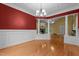 Elegant dining room boasting hardwood floors, classic wainscoting and views into the bright and airy living room at 2208 Wimberly Woods Dr, Sanford, NC 27330