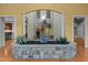 Elegant interior featuring a stone planter with fountain, hardwood floors, and an open archway to the living spaces at 2208 Wimberly Woods Dr, Sanford, NC 27330