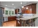 Well-equipped kitchen with granite countertops, hardwood floors, stainless steel appliances, and a breakfast bar at 2208 Wimberly Woods Dr, Sanford, NC 27330