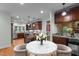 Bright eat-in kitchen featuring wood cabinets, stainless steel appliances, stone accents, and granite countertops at 2208 Wimberly Woods Dr, Sanford, NC 27330