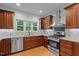 Spacious kitchen featuring modern appliances, custom cabinets, and hardwood floors, ideal for cooking and entertaining at 2208 Wimberly Woods Dr, Sanford, NC 27330