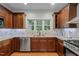 Modern kitchen featuring updated appliances, hardwood floors, and custom cabinets, perfect for culinary enthusiasts at 2208 Wimberly Woods Dr, Sanford, NC 27330