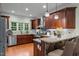 Well-equipped kitchen with granite countertops, hardwood floors, stainless steel appliances, and a breakfast bar at 2208 Wimberly Woods Dr, Sanford, NC 27330