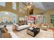 Bright and open living room with a balcony, stylish furniture, and views into the adjacent rooms at 2208 Wimberly Woods Dr, Sanford, NC 27330