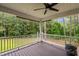 Back porch with wooded view and an outdoor ceiling fan at 2208 Wimberly Woods Dr, Sanford, NC 27330