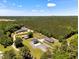 Aerial view of property with tree coverage showing the home, buildings, and driveway at 2258 Sanders Rd, Stem, NC 27581
