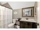 Beautiful bathroom features a shower with curtain, a vanity with mirror, and great natural light at 2258 Sanders Rd, Stem, NC 27581