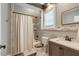 Well-lit bathroom with a shower-tub combo and tiled accents at 2258 Sanders Rd, Stem, NC 27581