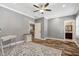 Spacious bedroom has a ceiling fan, hardwood floors, and convenient access to an adjacent bathroom at 2258 Sanders Rd, Stem, NC 27581