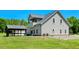 Back of house featuring a covered balcony, gray siding, and a covered patio at 2258 Sanders Rd, Stem, NC 27581