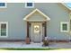 Inviting home entrance featuring a charming front door with a wreath and a decorative garden cart at 2258 Sanders Rd, Stem, NC 27581