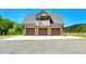 Spacious three-car garage with an upper balcony and beautiful curb appeal, perfect for car enthusiasts at 2258 Sanders Rd, Stem, NC 27581
