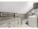Bright laundry room with white cabinets, granite counters, and modern appliances at 2258 Sanders Rd, Stem, NC 27581