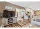 Spacious living area boasts sleek hardwood floors, a large television, and seamless transitions to the kitchen at 2258 Sanders Rd, Stem, NC 27581