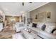 Open-concept living room features a modern decor, hardwood floors, and seamless flow to the dining area and kitchen at 2258 Sanders Rd, Stem, NC 27581