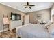 Comfortable main bedroom offers ample natural light, a ceiling fan, and neutral paint colors at 2258 Sanders Rd, Stem, NC 27581