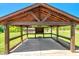 Covered backyard patio with grill, lights, and an outdoor seating area at 2258 Sanders Rd, Stem, NC 27581