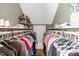 Well-organized walk-in closet boasts shelving and hanging rods for clothing and shoe storage at 2258 Sanders Rd, Stem, NC 27581
