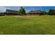 Expansive backyard with lush green grass and a charming farmhouse in the background at 2371 Nc 210, Smithfield, NC 27577