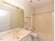 The bathroom features a single sink vanity and a shower-tub combo with black and white floor at 2371 Nc 210, Smithfield, NC 27577