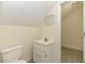 Compact bathroom featuring a toilet, sink with vanity, mirror, and entrance to another room at 2371 Nc 210, Smithfield, NC 27577