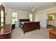 This spacious bedroom includes a ceiling fan and neutral carpet with an ensuite bathroom at 2371 Nc 210, Smithfield, NC 27577