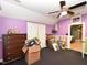 Bright bedroom featuring a ceiling fan, hardwood floors, and adjacent rooms at 2371 Nc 210, Smithfield, NC 27577