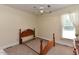 This bedroom offers neutral carpet and a window with natural light; bedframe only at 2371 Nc 210, Smithfield, NC 27577