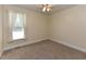 This simple bedroom has carpeting, natural light, and white trim at 2371 Nc 210, Smithfield, NC 27577
