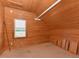 This cozy bedroom features a wood plank ceiling and walls with a window view at 2371 Nc 210, Smithfield, NC 27577