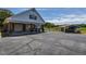 Wide driveway with a two-car garage, carport, and additional covered parking area at 2371 Nc 210, Smithfield, NC 27577