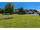 Expansive front yard with a charming brick home and detached garage under a clear blue sky at 2371 Nc 210, Smithfield, NC 27577