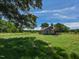 Exterior view showcasing the older home with mature trees and expansive green space at 2371 Nc 210, Smithfield, NC 27577
