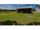 View of an exterior storage structure with wooden post and beam support in a grassy yard at 2371 Nc 210, Smithfield, NC 27577