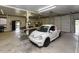Spacious garage with a white car parked inside, featuring ample workspace and storage at 2371 Nc 210, Smithfield, NC 27577