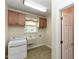 The laundry room features a utility sink, cabinets, and a window allowing natural light at 2371 Nc 210, Smithfield, NC 27577