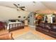 Comfortable living room with hardwood floors, ceiling fan, leather couches, and an open kitchen nearby at 2371 Nc 210, Smithfield, NC 27577